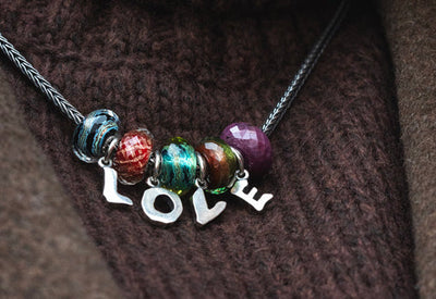 Trollbeads bracelet with a b letter tassel, green glass and gemstones with silver beads and pearl