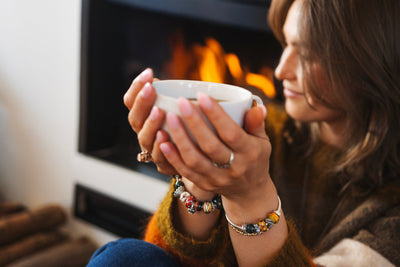 Model standing in a flower garden wearing Trollbeads jewellery